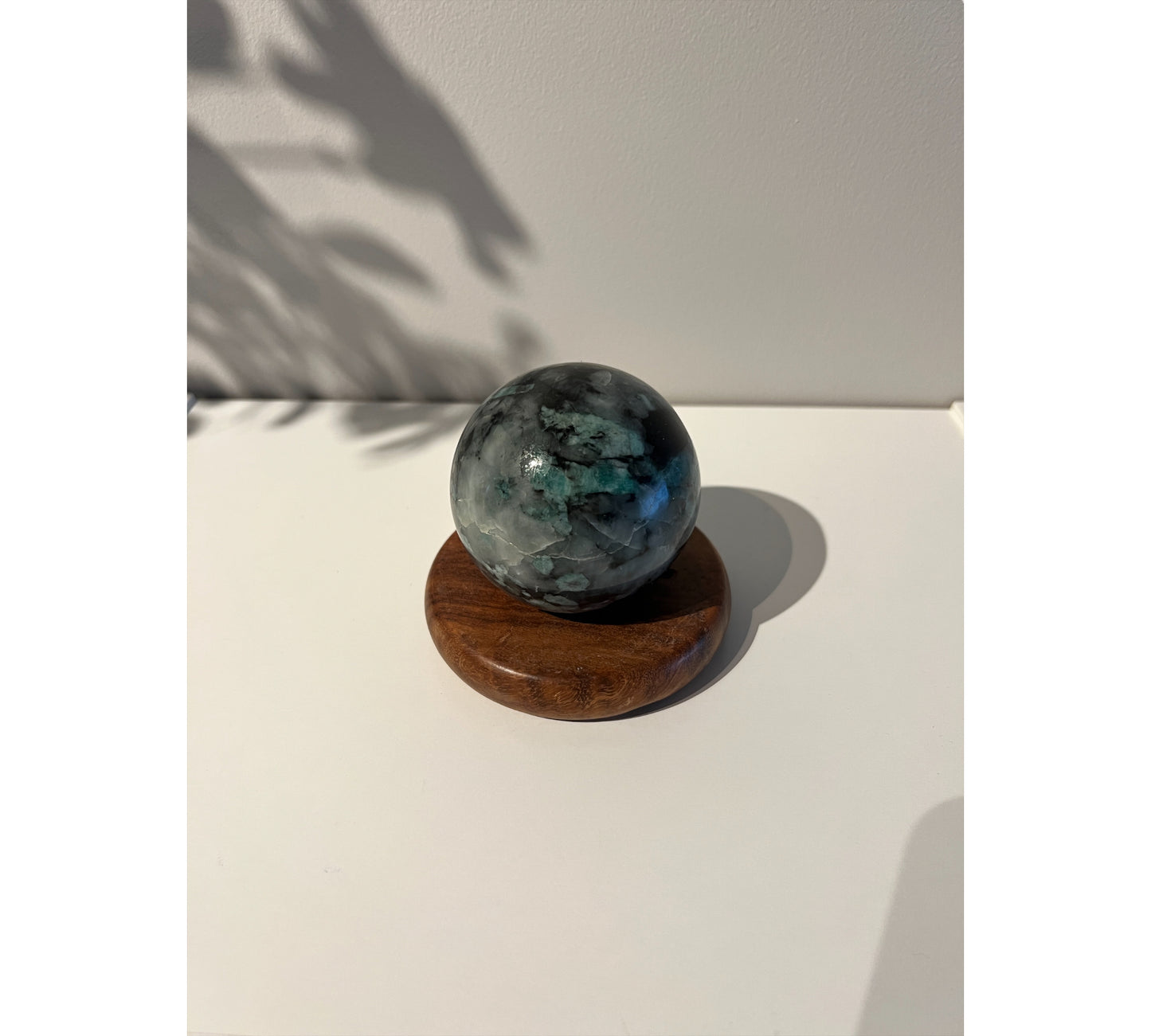 Emerald - sphere on a wooden plinth