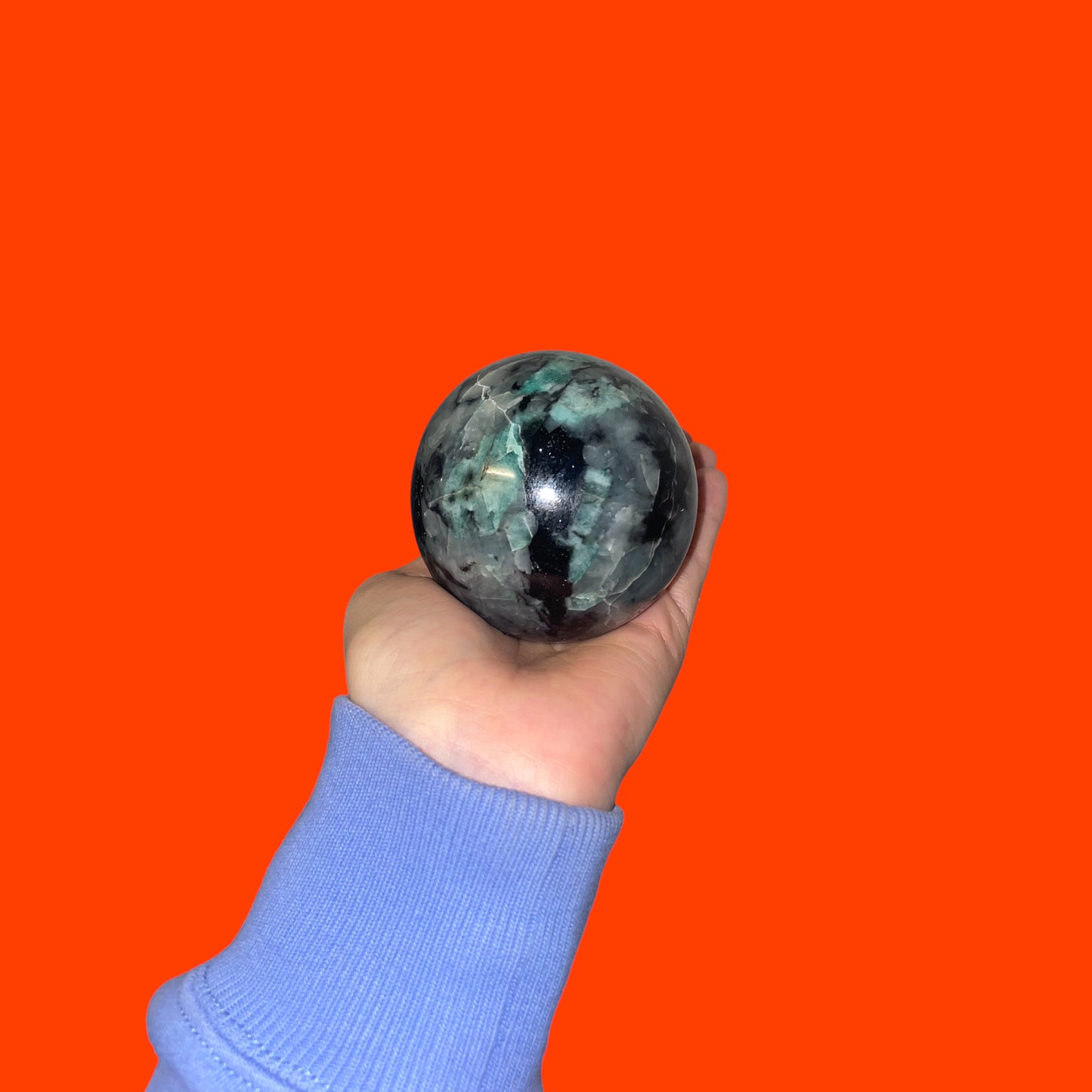 Emerald - sphere on a wooden plinth